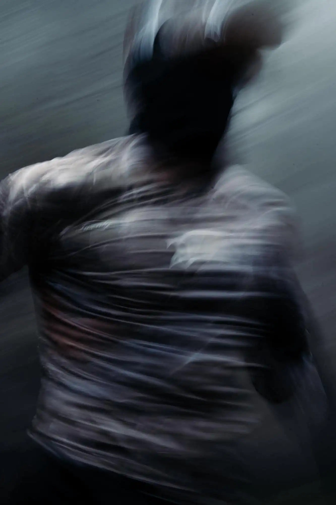 Blurred action shot of a person running, emphasizing speed and movement.