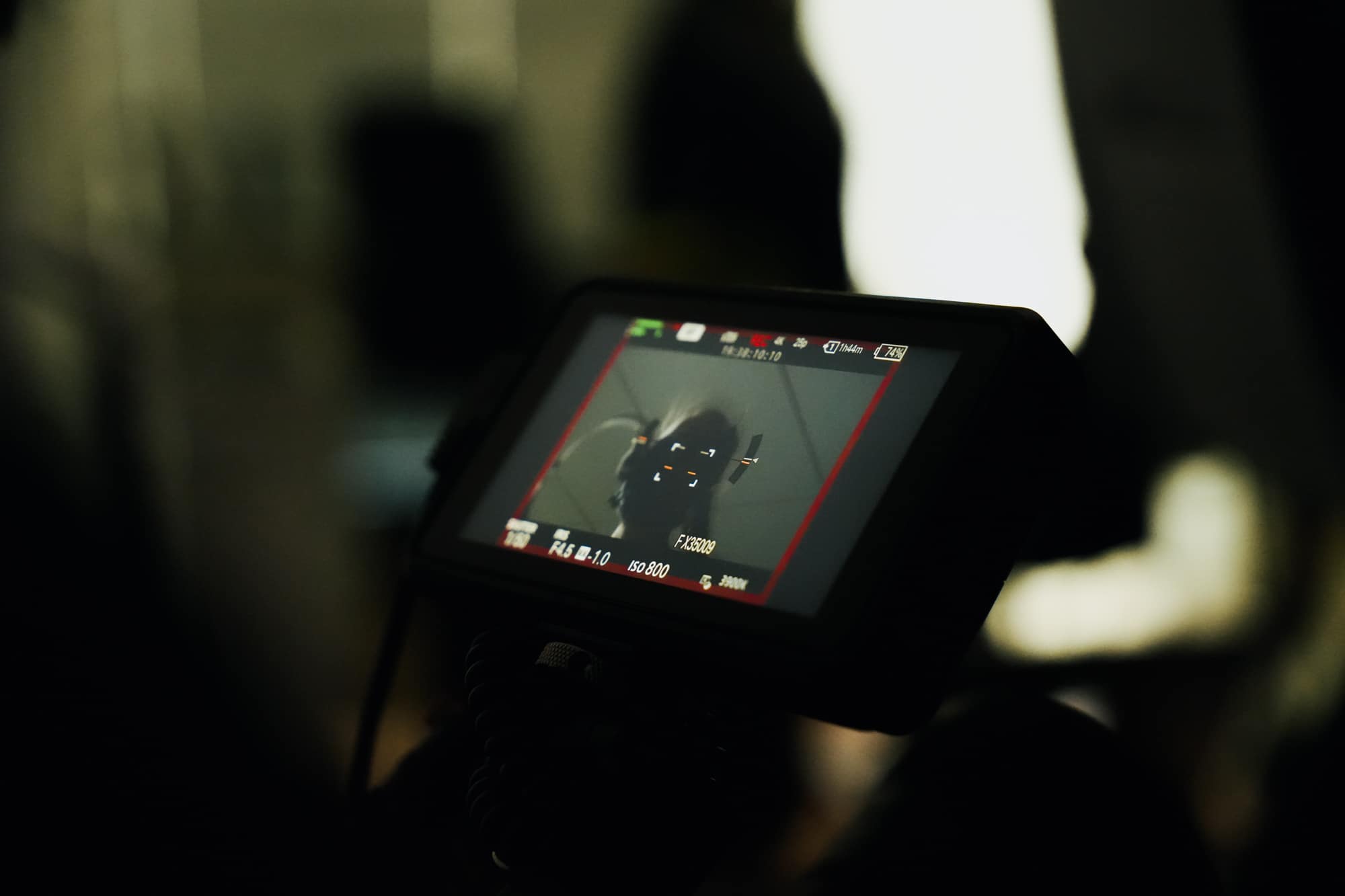 Close-up of a camera screen displaying a person in motion, possibly during a workout or exercise session.